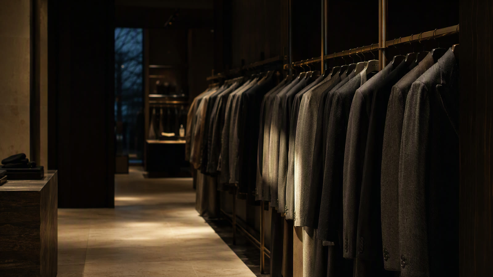 Editorial view of clothing on a rail in a softly lit boutique